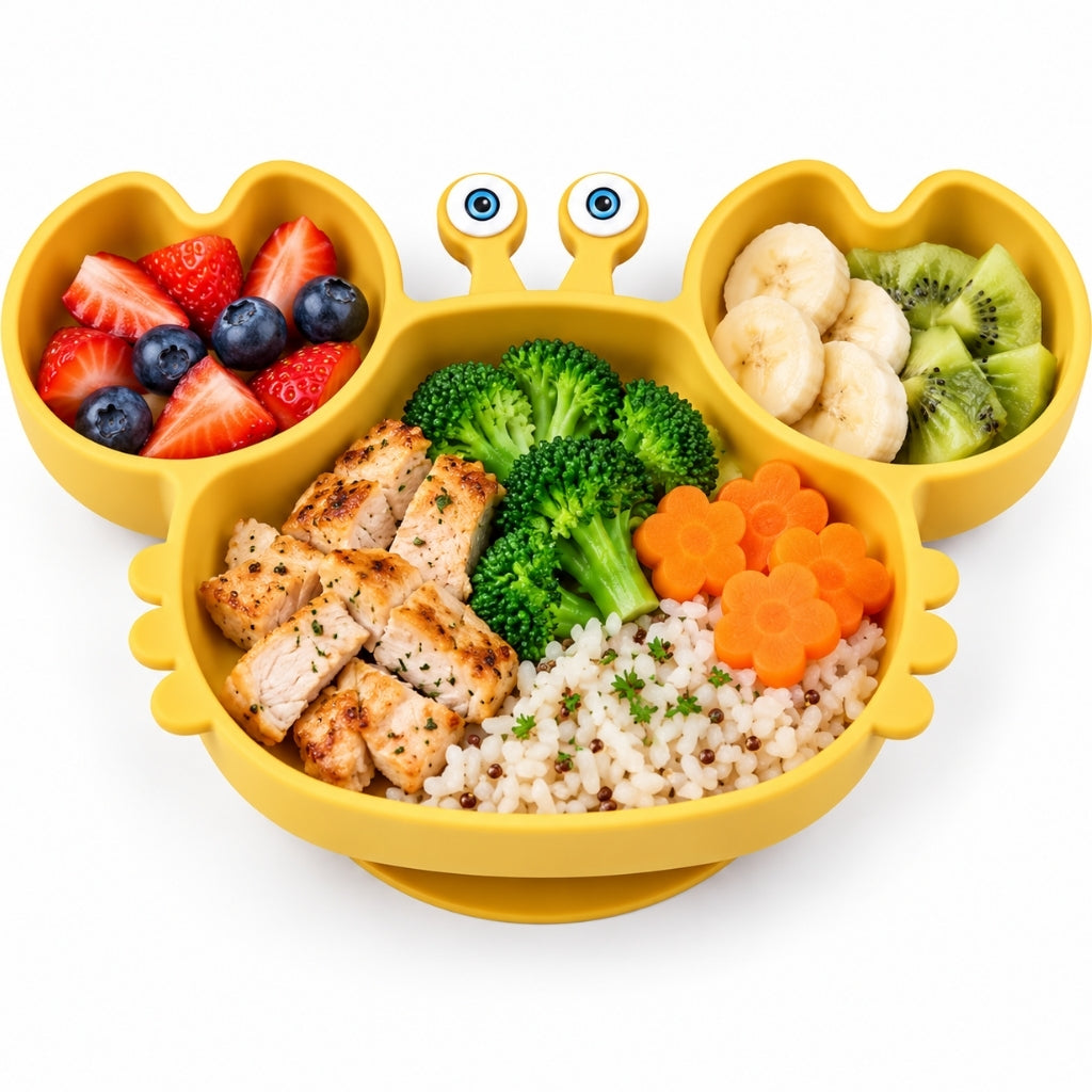 Assiette crabe jaune garnie de fruits dans les pinces, poulet, riz, brocoli et carottes au centre